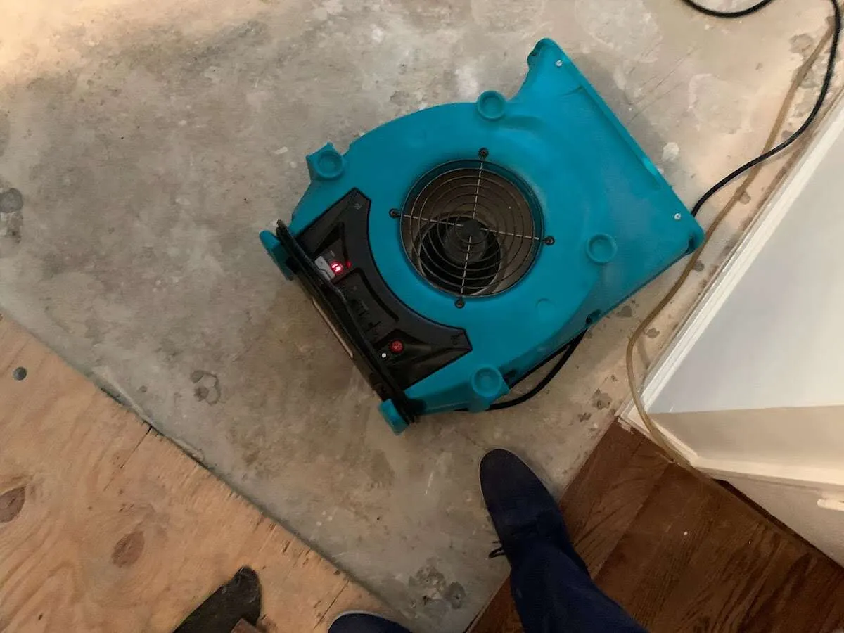 Air mover drying subfloor during Commercial Water Damage Restoration in Dunwoody